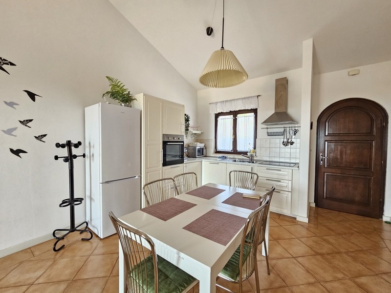Kitchen with dining area and solid wooden door
