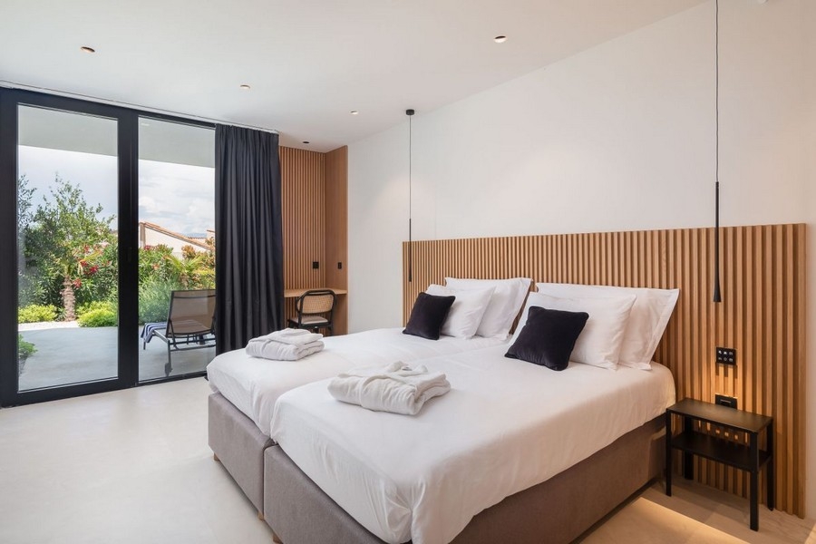 Bedroom with wooden wall and garden access