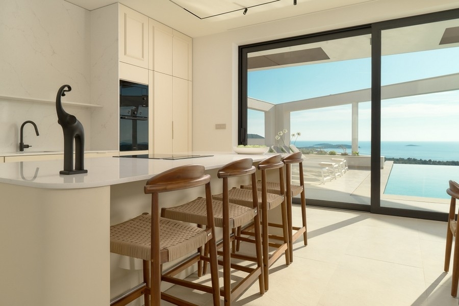 Kitchen with bar counter and view of pool and sea