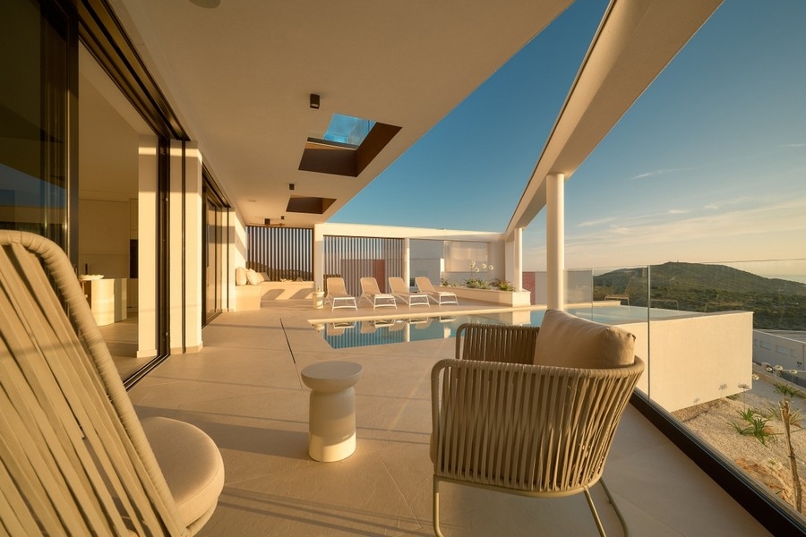 Covered terrace with pool and sea views