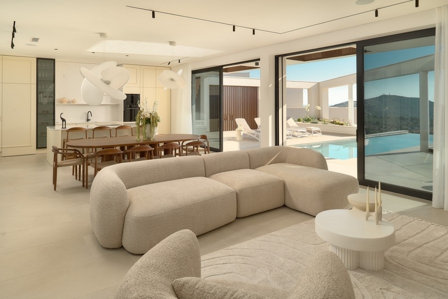 Open living area with kitchen and pool access