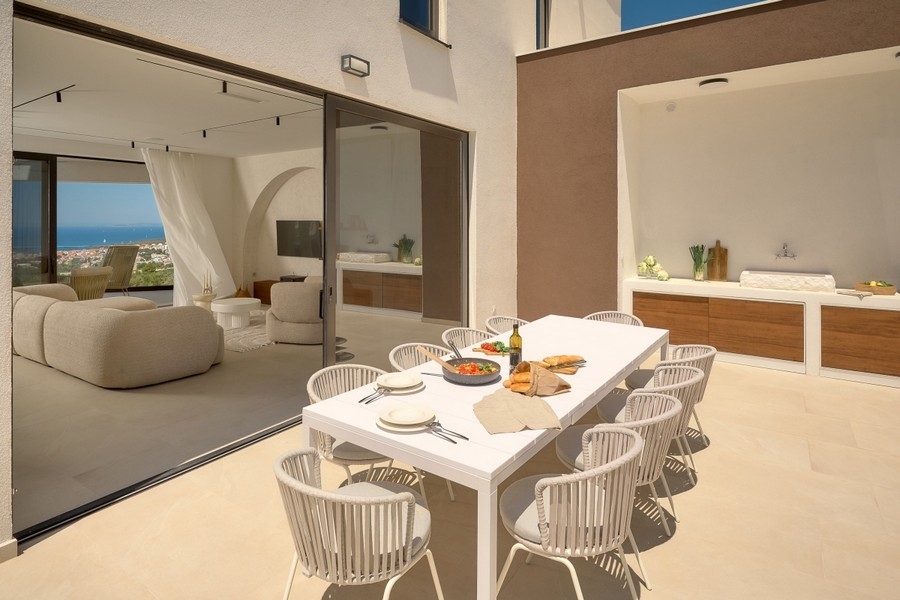 Living and dining area with a set table and sea views
