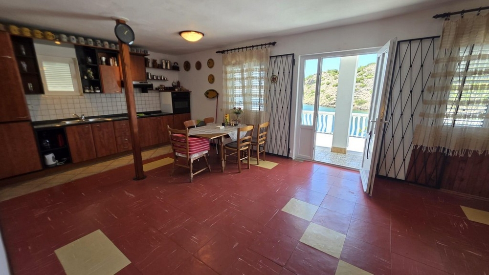 Living room with kitchen and terrace access