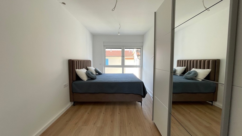 Bedroom with double bed and mirror cabinet