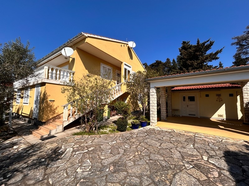 Side view of the house with external stairs and parking space