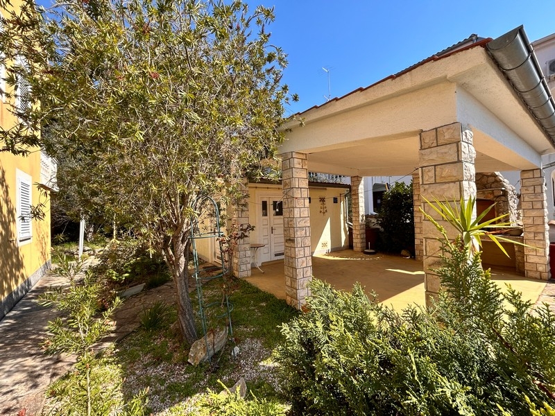 Covered terrace with stone pillars on the house