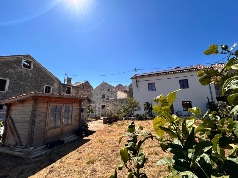 Garden with garden house and view of stone houses