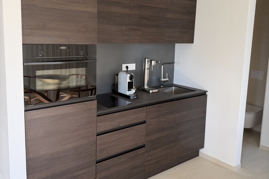 Kitchen with oven and coffee machine