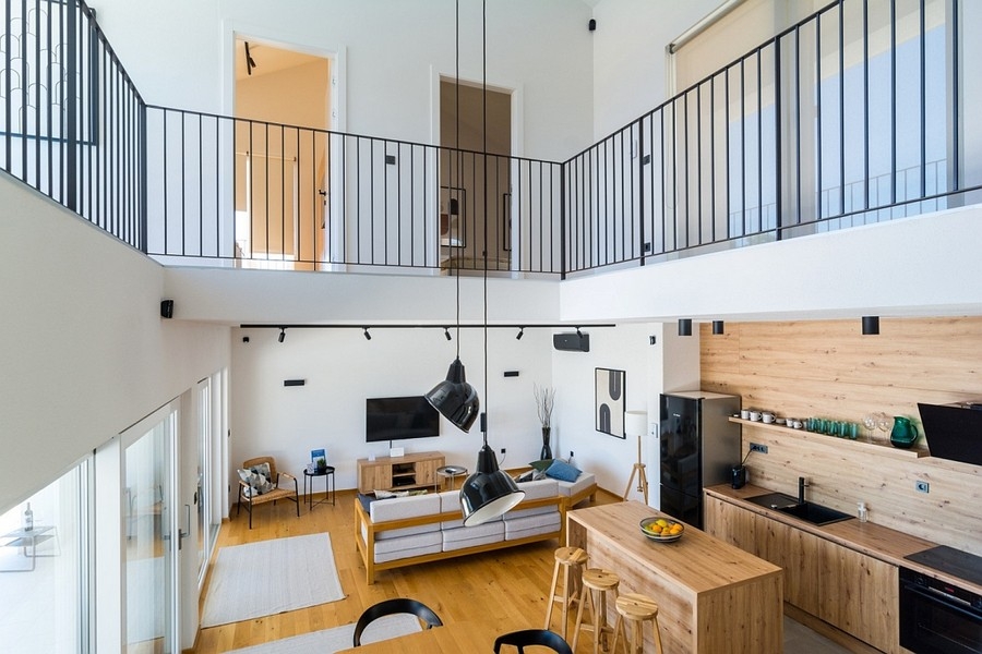 Open living area with gallery and kitchen