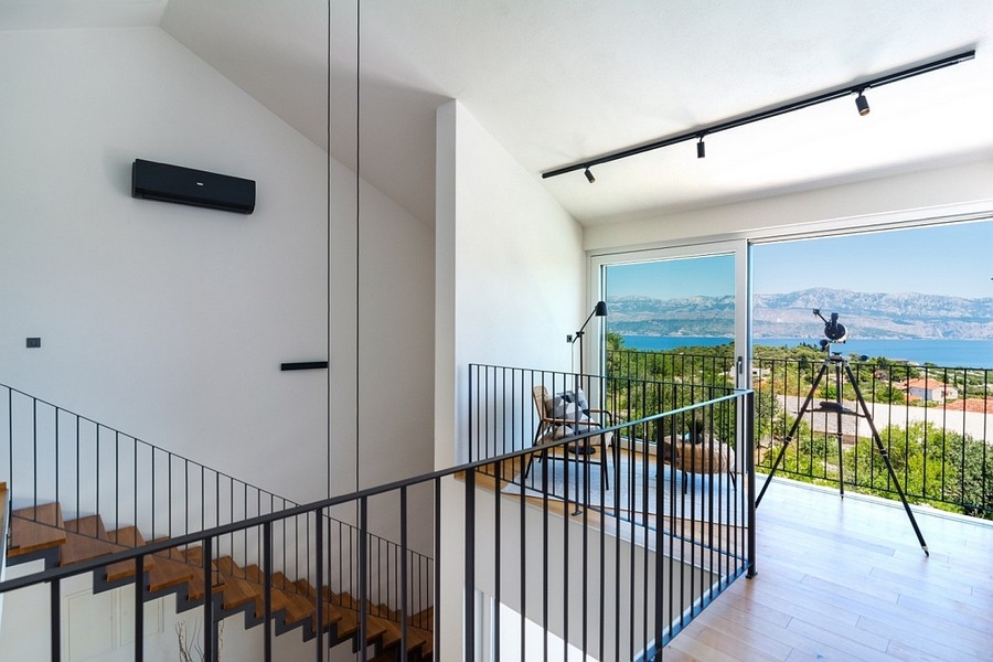 Staircase area with balcony access and sea views