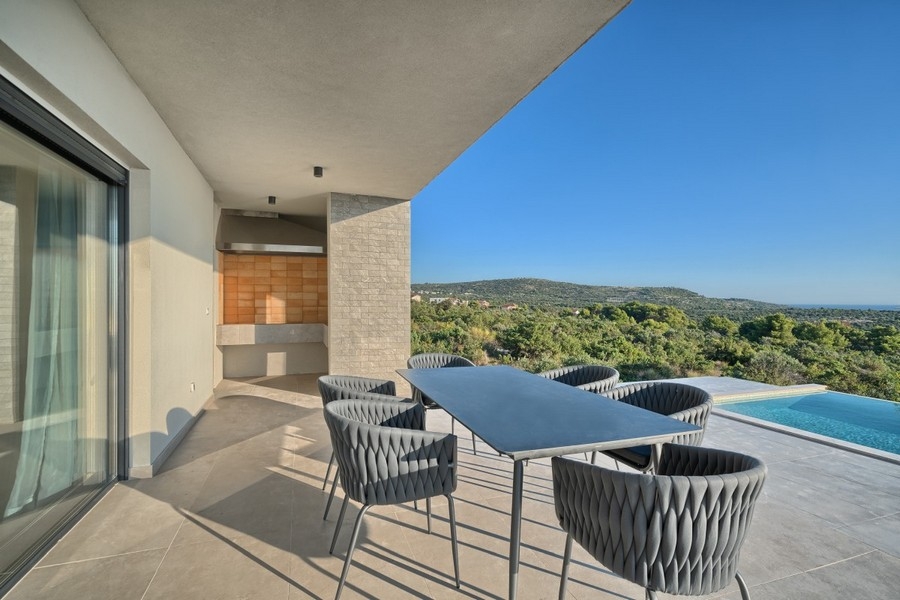 Covered terrace with seating area and view