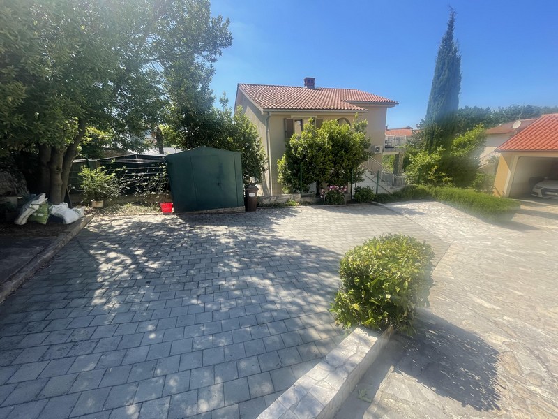Paved forecourt with garden