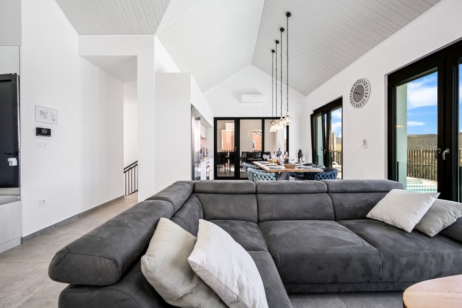 Living room with large corner sofa and window front