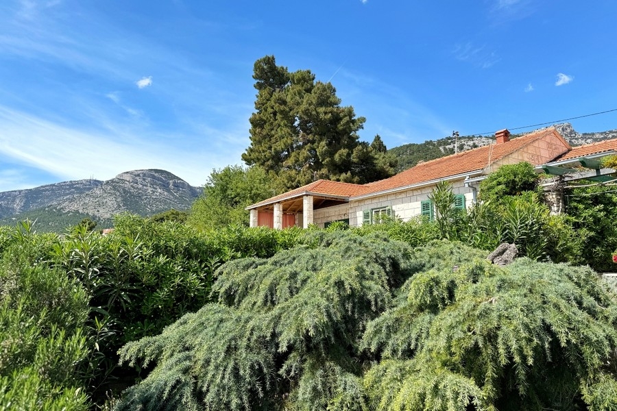 Mediterranean garden with stone houses and mountain views