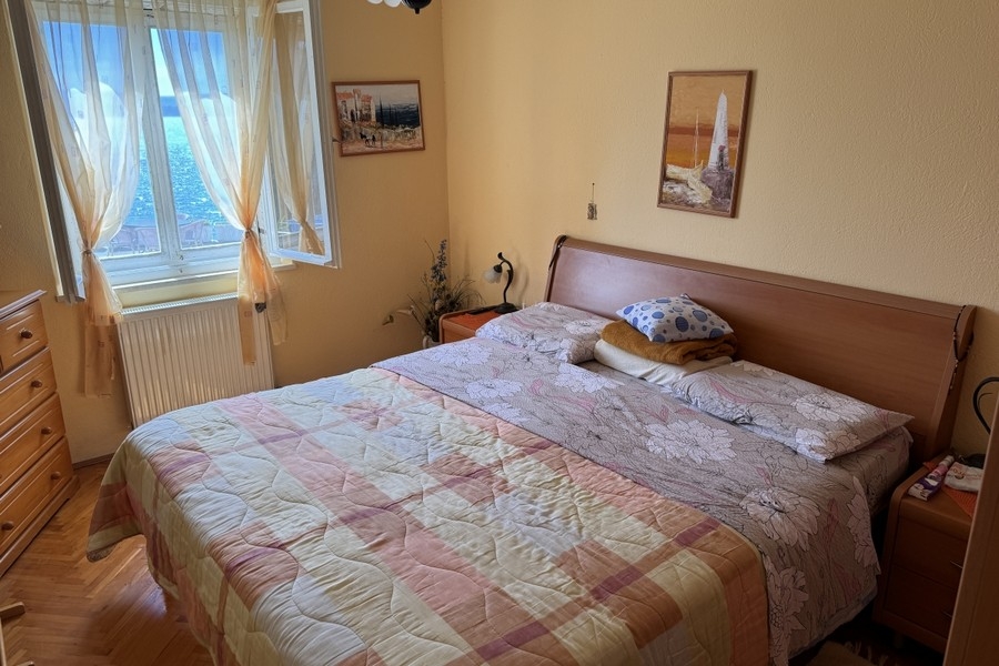 Bedroom with window and sea view in Croatia