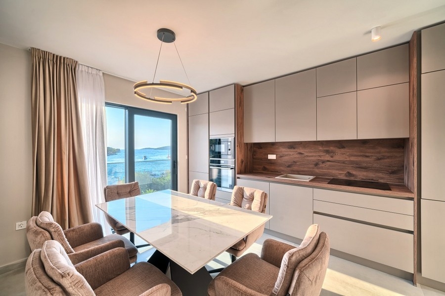 Dining area with modern kitchen and sea views