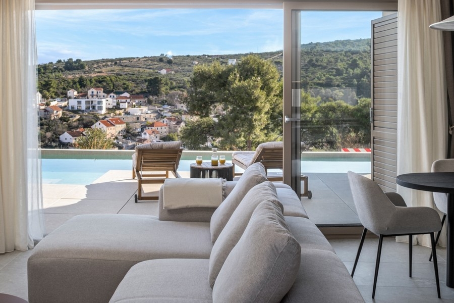 Living area with large windows facing the terrace