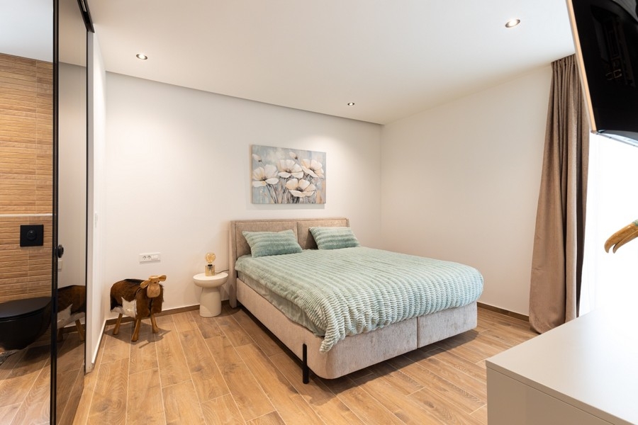 Bedroom with double bed and wooden floor