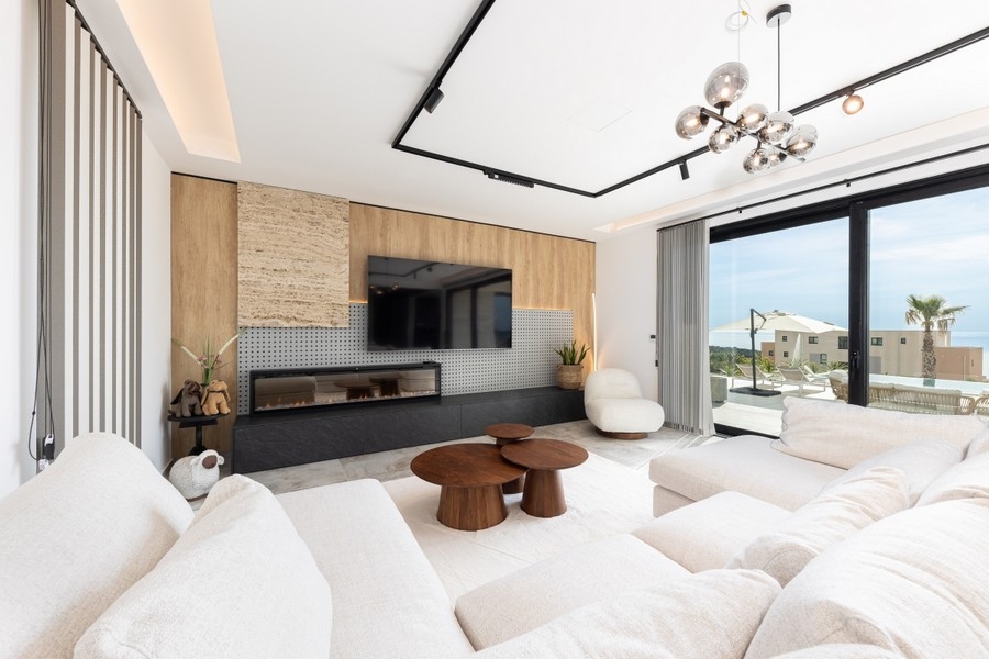 Bright living room with window front and sea view