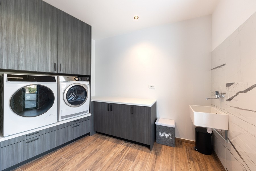 Utility room with washing machine and dryer