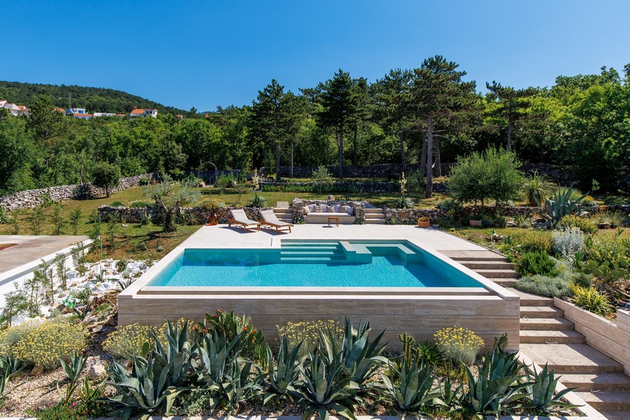 Swimming pool with sun loungers and gardens