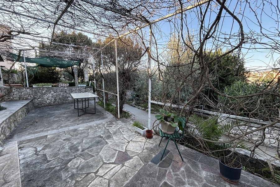 Mediterranean garden with pergola and natural stone terrace