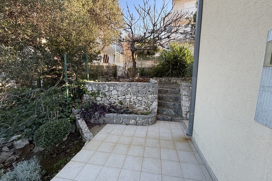 Well-kept garden with natural stone wall