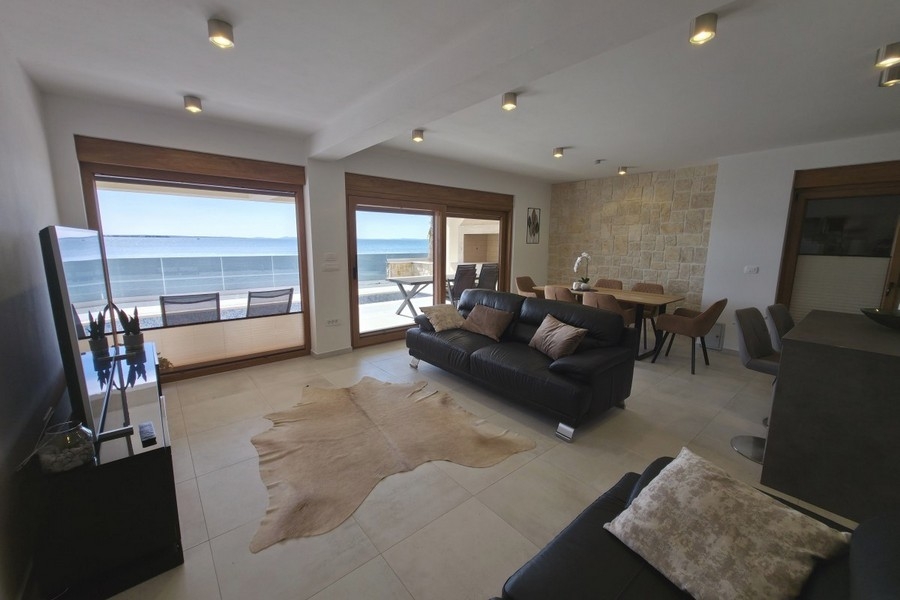 Living area with large glass front and sea views