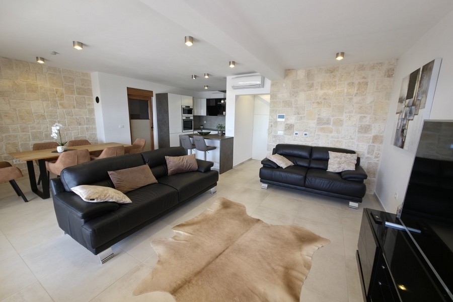 Living area with sofas and natural stone wall