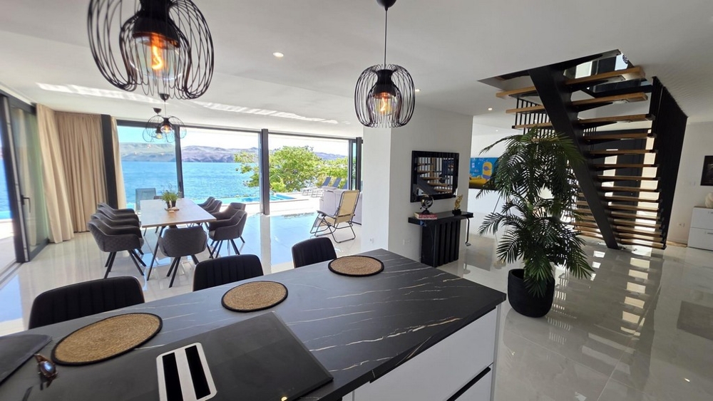 Open plan living area with kitchen and sea views