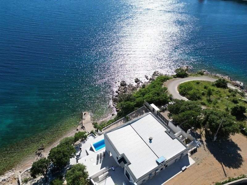 Crystal clear sea and rocky beach below the villa