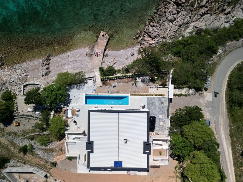 Aerial view of property and pool with beach access