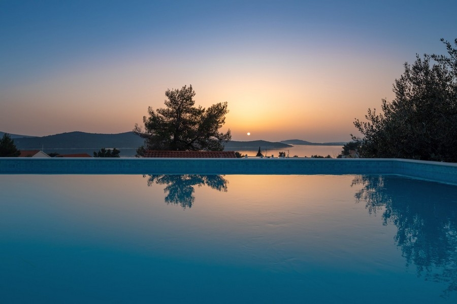 Infinity pool at sunset with panoramic sea views