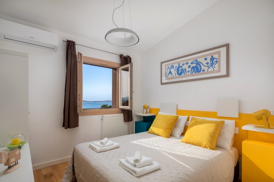 Ocean view bedroom with yellow accents