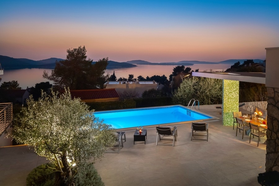Pool with summer kitchen and sea views in the evening