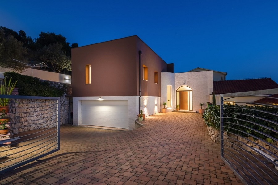 Illuminated villa with modern facade at dusk