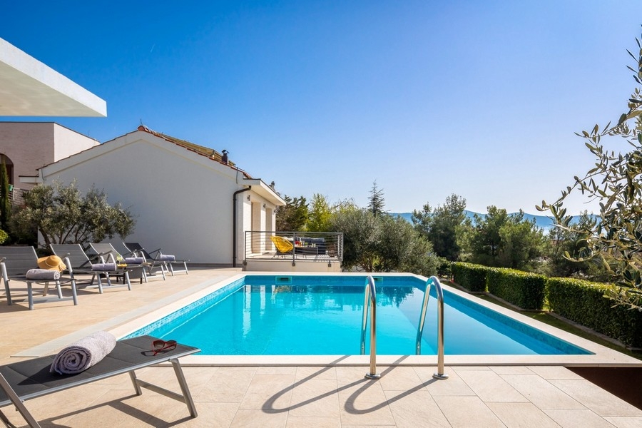 Swimming pool with sunbeds and sea views