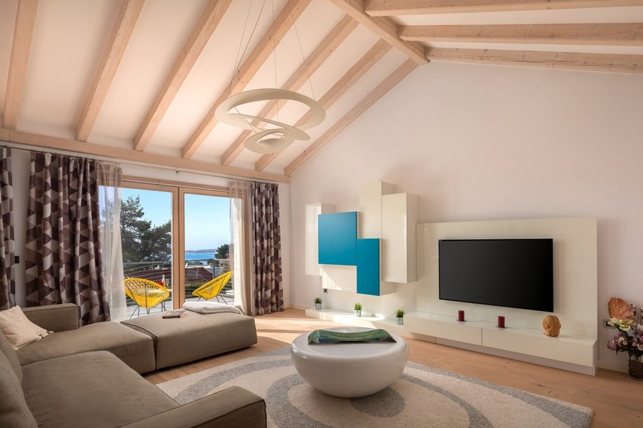 Bright living area with wooden ceiling and sea views