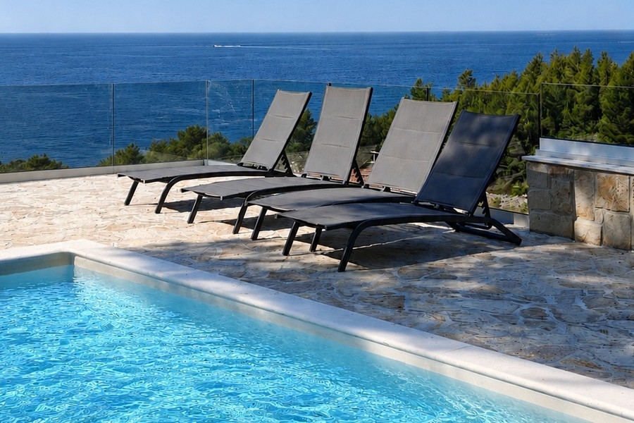 Swimming pool with sunbeds and sea views
