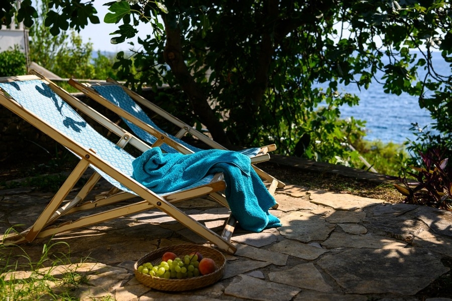 Deck chair in the garden right by the sea