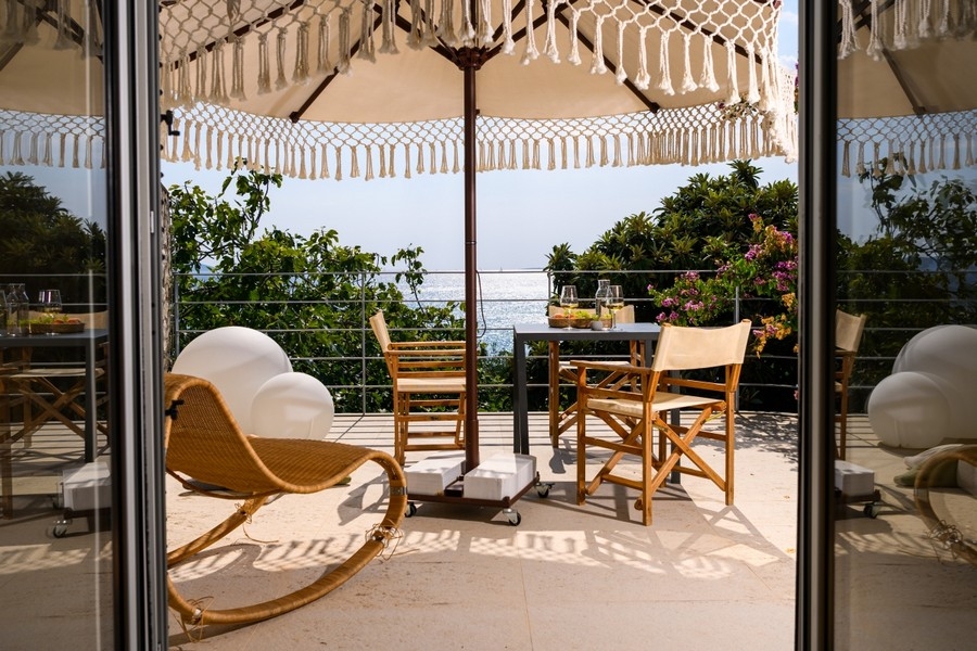 Covered terrace with seating area and sea views