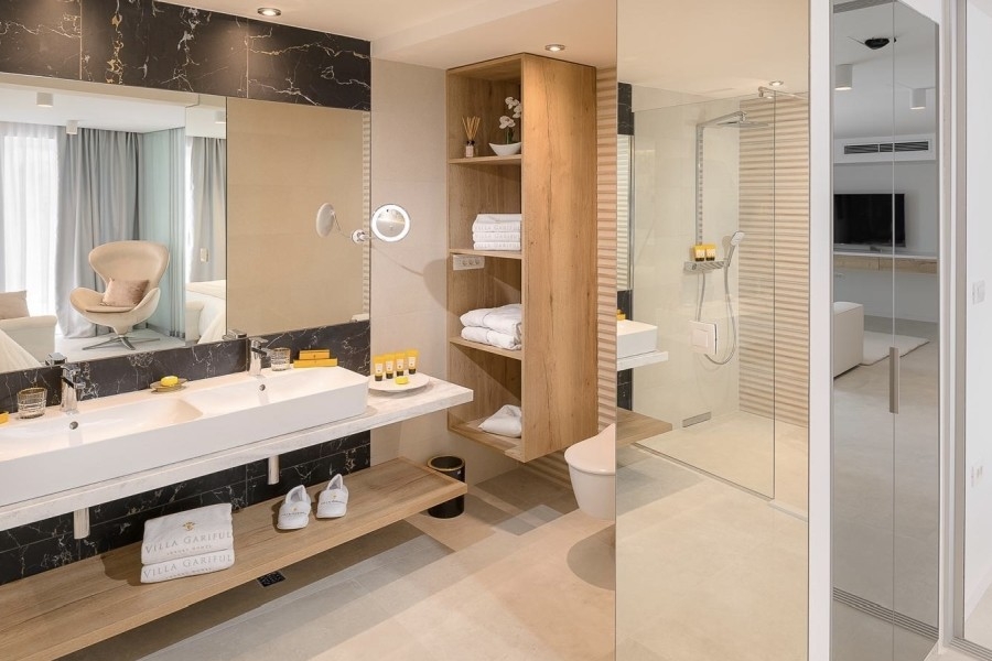 Bathroom with double vanity and shower
