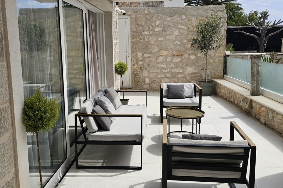 Terrace with seating area and natural stone wall