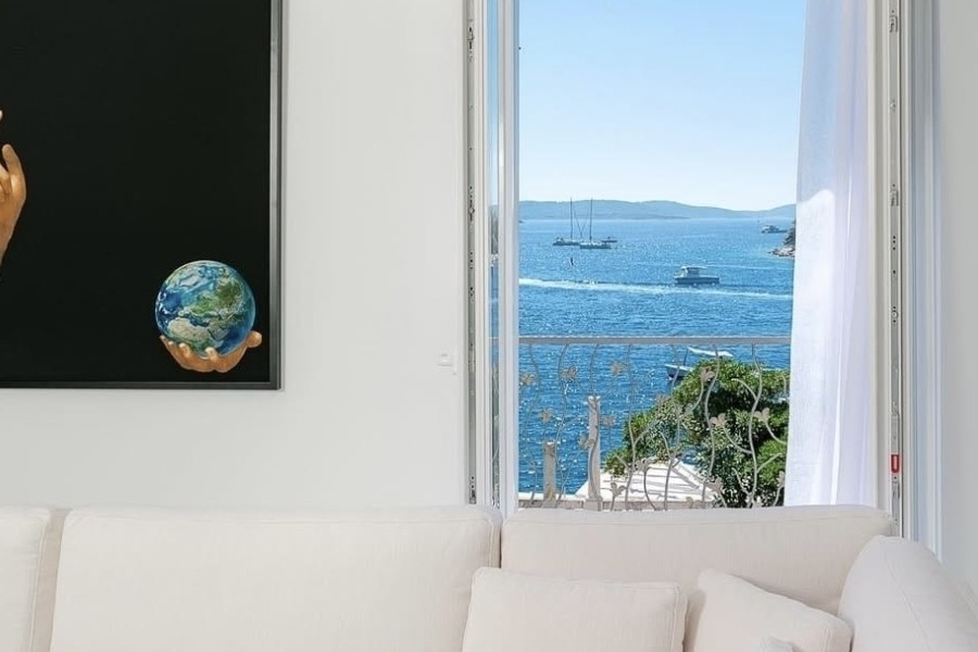 View of the sea through a window of the villa