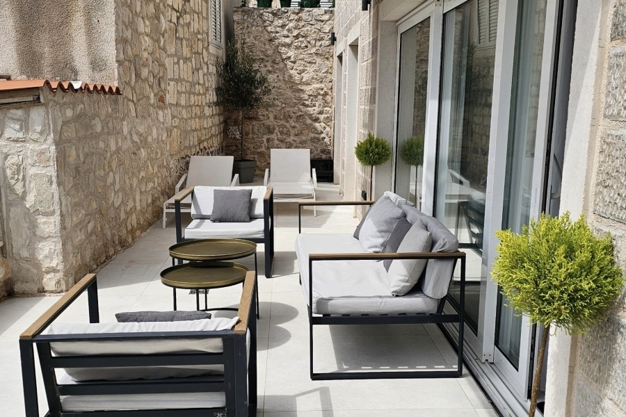 Terrace with armchairs and natural stone wall