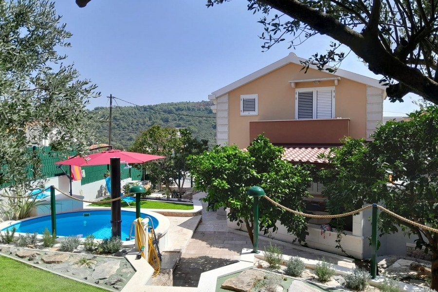 Exterior view of the house with garden and pool