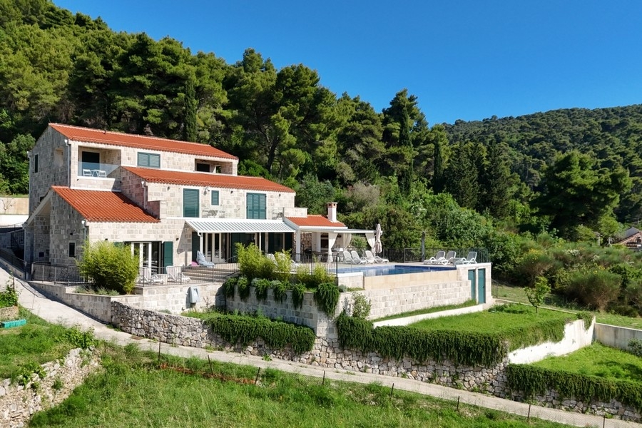 Villa with stone facade, garden and swimming pool