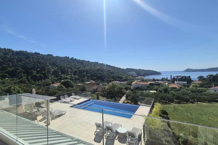 Pool terrace with sun loungers and sea views