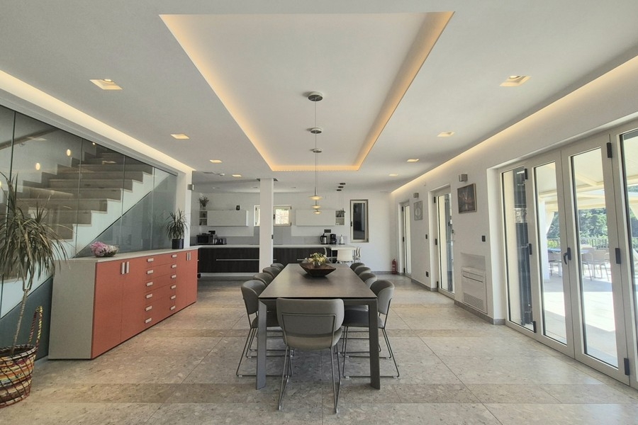 Open living area with dining table and kitchen