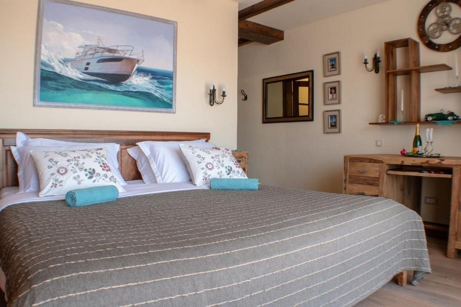 Bedroom with double bed and maritime picture